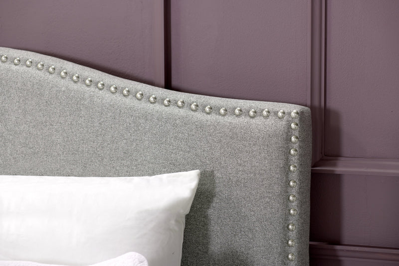 Lit plateforme rembourré Cove en tissu gris avec clous décoratifs - format grand lit